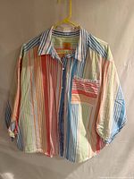 Front view of multicolor striped blouse on hanger
