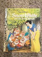 Front cover showing title, Snow White and dwarfs, gold foil spine
