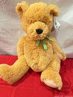 Full view of tan 22" plush teddy bear sitting with green gingham bow