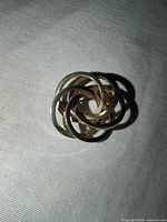 Front view of interlocking swirl brooch