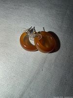 Earrings lying flat showing hoop shape and post backs