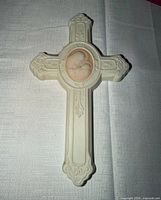 Front view of ivory wall cross with Madonna and Child relief
