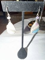 Full view of both enamel drop earrings on stand