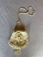 Full view of cream lace bridal purse with strap extended