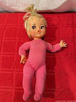 Full view of 18" Posie doll on red background