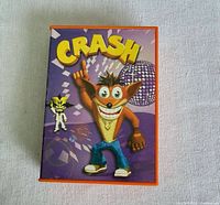 Front lid displaying Crash Bandicoot artwork and title on orange handheld game
