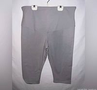 Front view of gray capri leggings on hanger