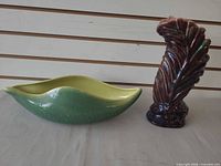 Beauceware green leaf-shaped planter and unmarked purple-brown vase side by side