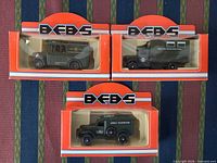 Front view of three boxed Lledo BFBS military broadcasting vehicles