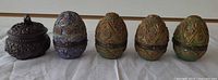 five hinged egg trinket boxes closed, side view