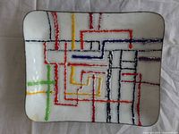 Front of dish showing abstract multicolored design