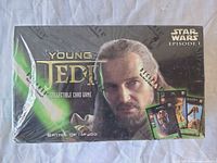 Front of sealed booster box with Qui-Gon Jinn artwork and shrink wrap