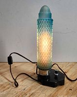 Lamp illuminated showing uranium glass glow and cord with inline switch