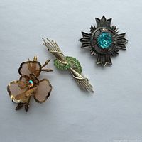 Overview of all three brooches