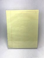 Front view of acrylic sign holder with letter-size pad for scale