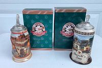 Front view of both steins with boxes