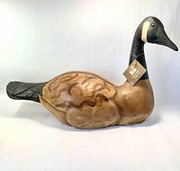Left side view of carved wood Canada goose with tag visible