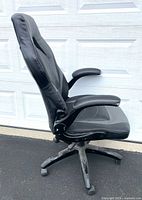 Left side profile of chair showing armrest and base
