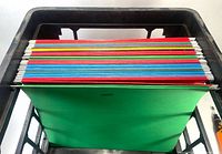 Top view of multicolor hanging folders inside crate