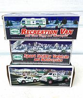 Front artwork of three Hess toy truck boxes stacked