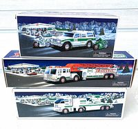 Three Hess toy truck boxed sets stacked showing artwork