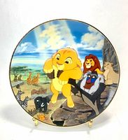Front view of plate showing Lion King scene and gold rim