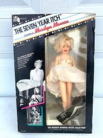 Front of boxed Marilyn Monroe doll, clear view of doll and graphics