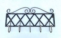 Front view of rectangular wrought iron coat rack with five hooks and scroll accents