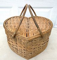 Front angled view showing heart shape, weave pattern, handles