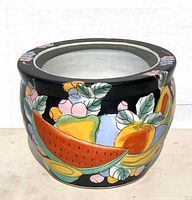 Side view showing full fruit motif on glossy black background