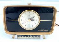 Front view showing clock dial, tuning scale, RCA Victor logo