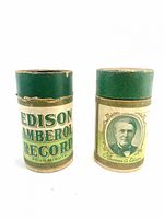 Two Edison Amberol record containers, front graphics visible