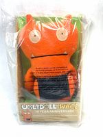 Front view of sealed Uglydoll Wage plush in box