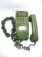 Front view showing entire green wall phone with handset and cord