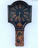 Full view of black and gold chinoiserie wall clock