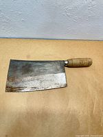 Front view of cleaver showing full blade, handle, rust, and maker mark