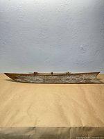 Full side view of wooden canoe model