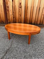 Full view of oval cherry wood coffee table