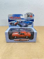 Front of packaged 1:43 red 1969 Chevrolet Camaro diecast model