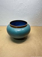 Front view of turquoise cloisonné bowl showing exterior pattern and form