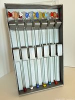 boxed set of six clear glass swizzle sticks with candy-shape tops