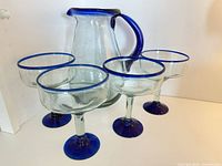 Group shot of pitcher and four glasses showcasing matching cobalt accents