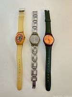Group shot of all three Swatch watches showing cases and straps