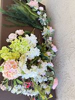Overhead view of garland, hydrangea bouquet, assorted stems and greenery