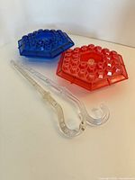 Red and blue hexagonal tops with two clear hanging rods