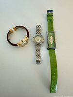 Group shot of all three wristwatches showing overall design and relative sizes