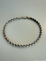 Full view of sterling silver twisted link bracelet formed in a circle