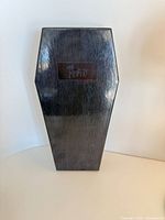 Closed coffin-shaped Misfits box front view