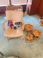 Full view of bamboo armchair with cushion, three tables, slider packs