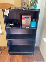 Front view of black three-shelf Room Essentials bookcase